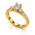 Pear moissanite three-stone engagement ring with pear side stones and pavé band, angled view